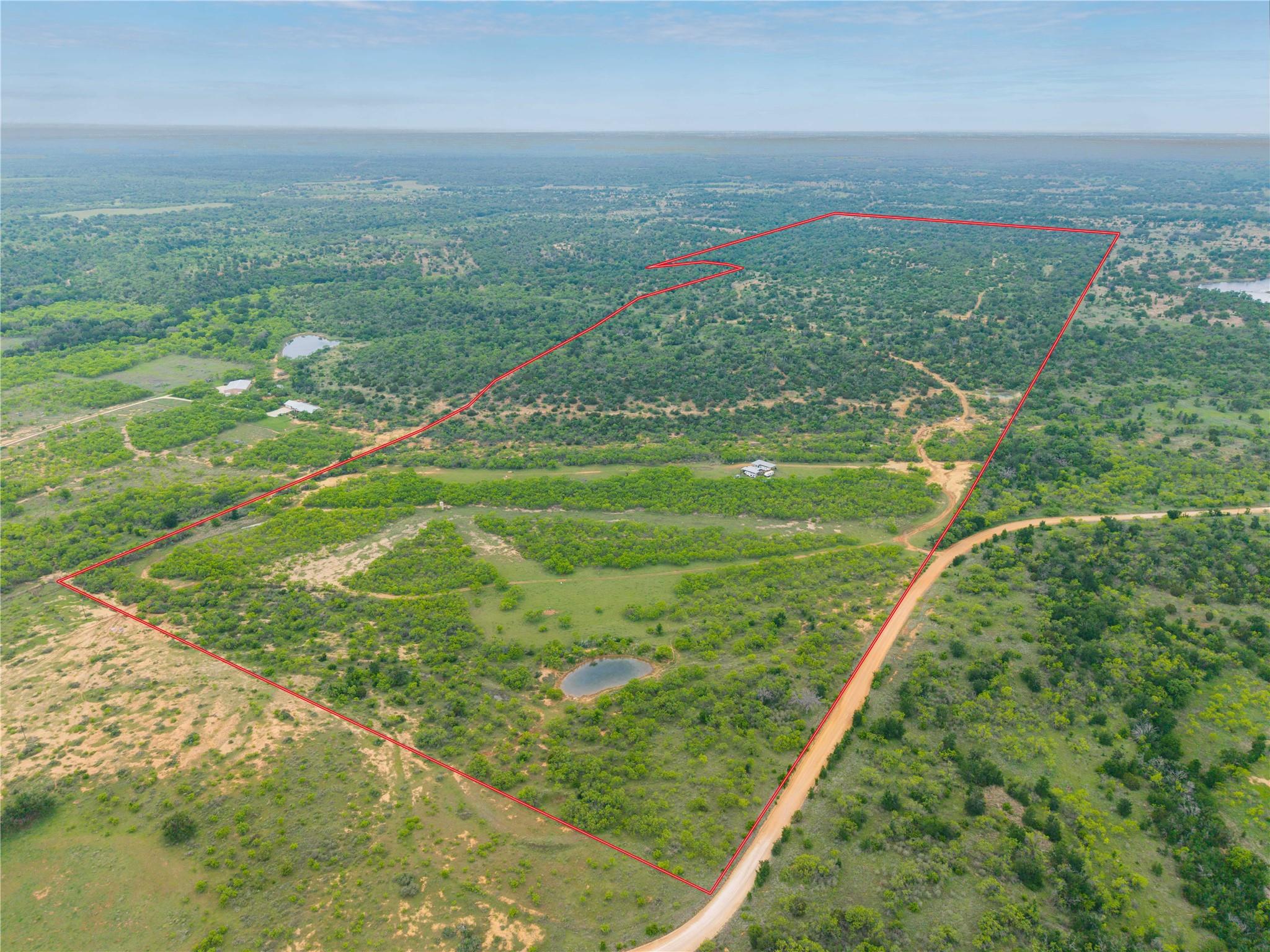 Expansive undeveloped land featuring a red-lined 