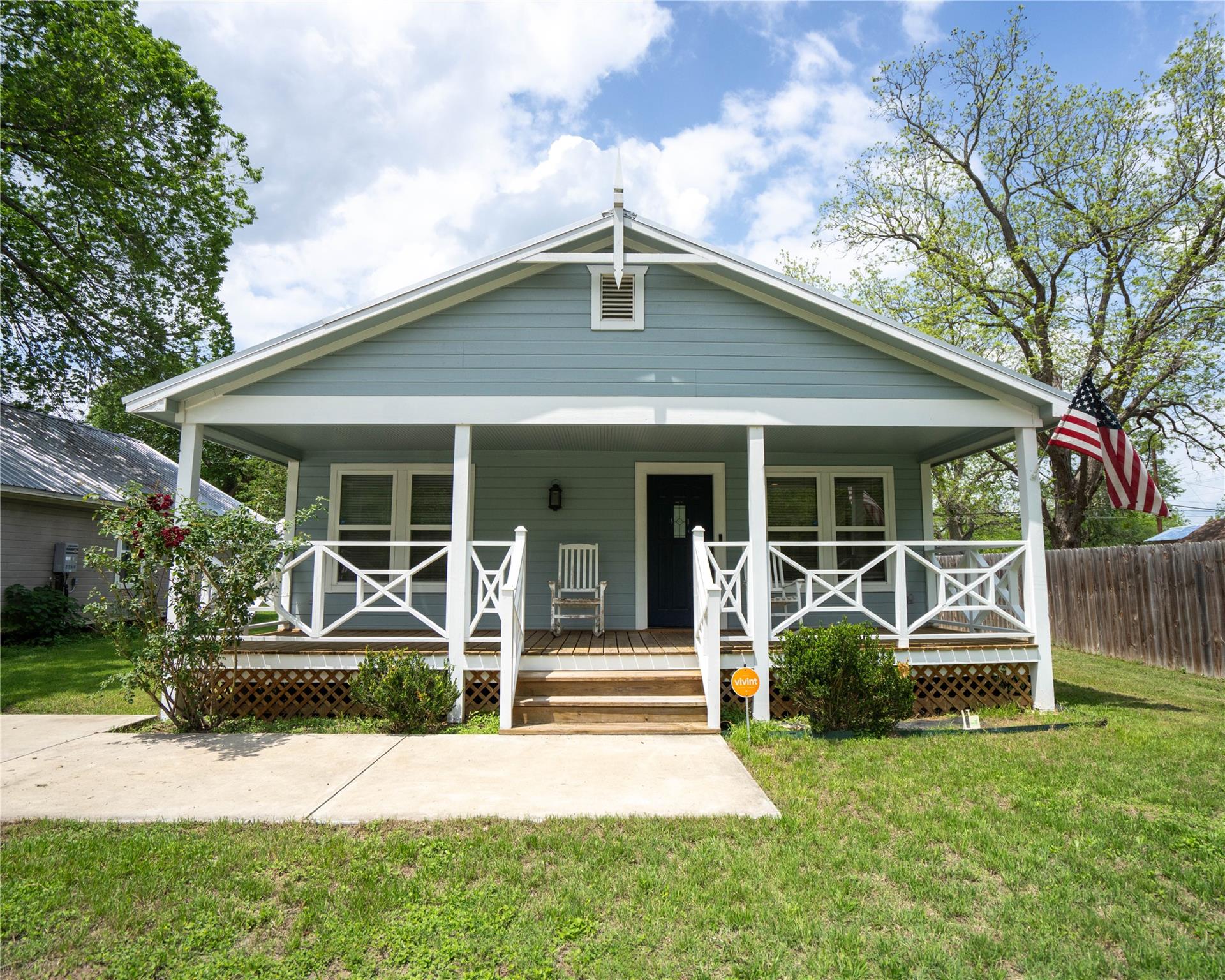 Light blue exterior siding with white trim, a cov