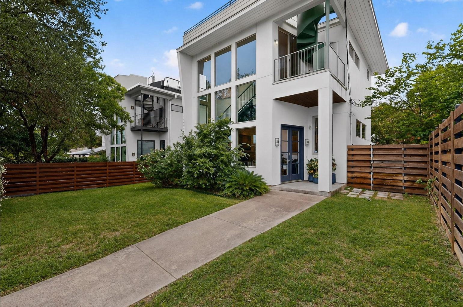 Modern white exterior featuring extensive glazing