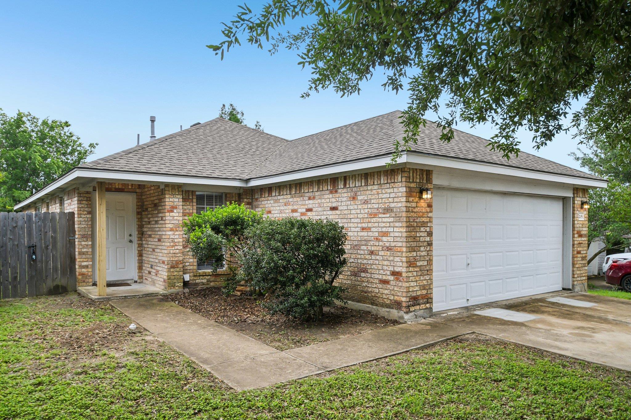 Brick exterior with a white garage door
