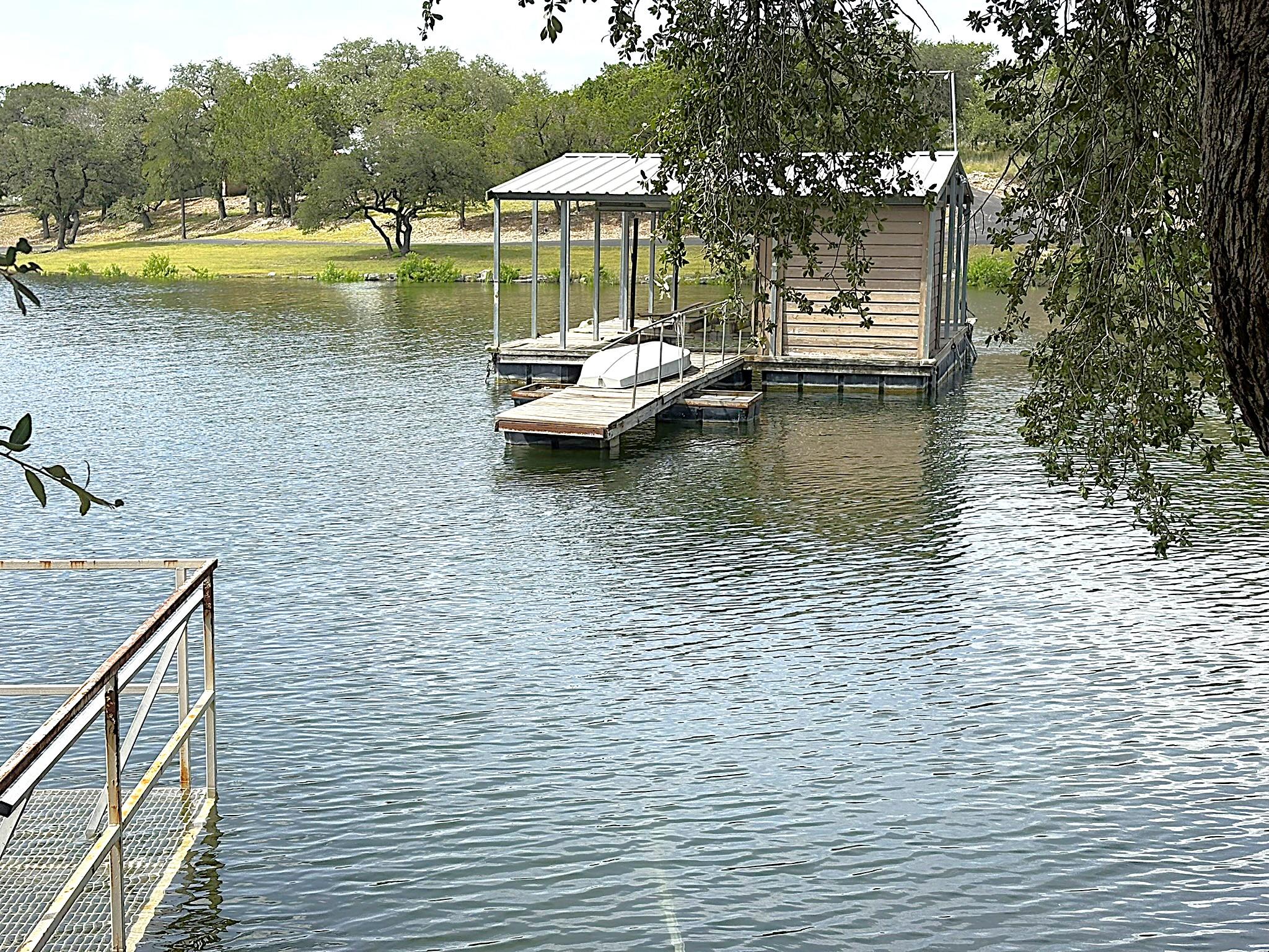 Boathouse with covered dock sits on the tranquil 