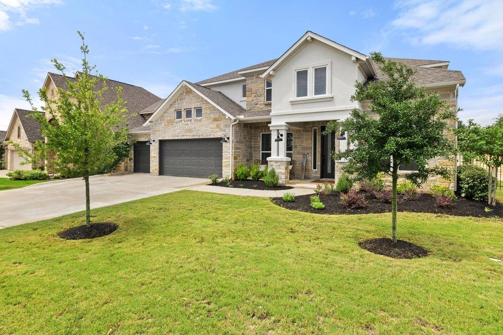 Stone and stucco exterior featuring multiple gabl