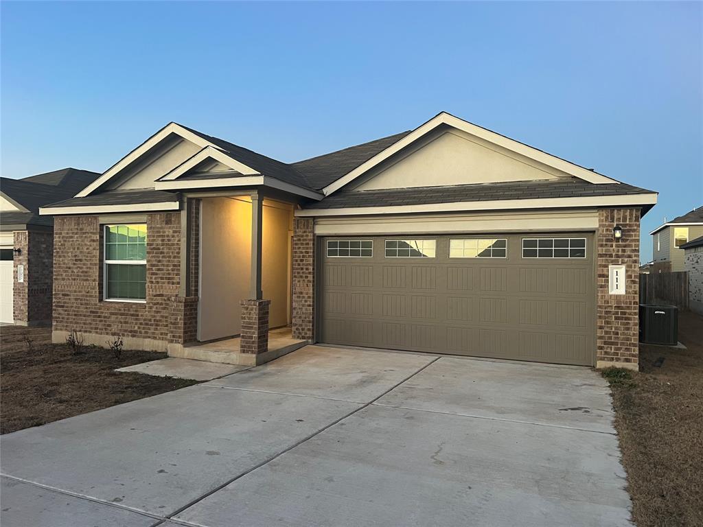 Brick-front residence featuring a covered entry a
