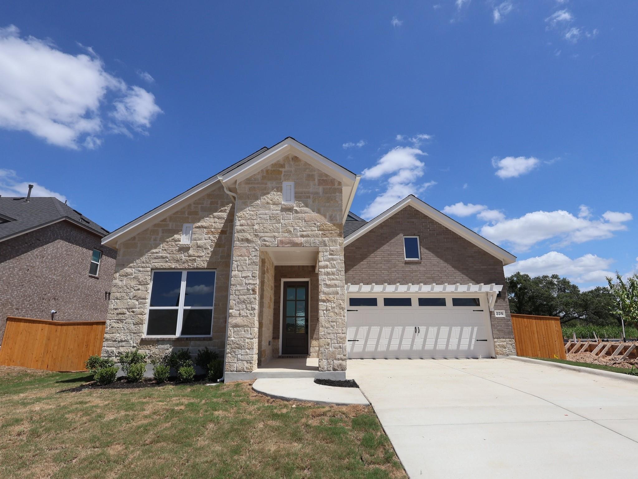 A well-maintained lawn welcomes you to this moder