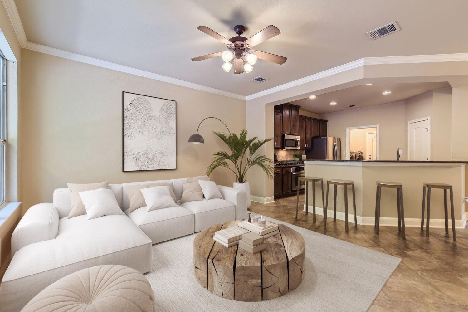 Open-concept living area with crown molding, a ce
