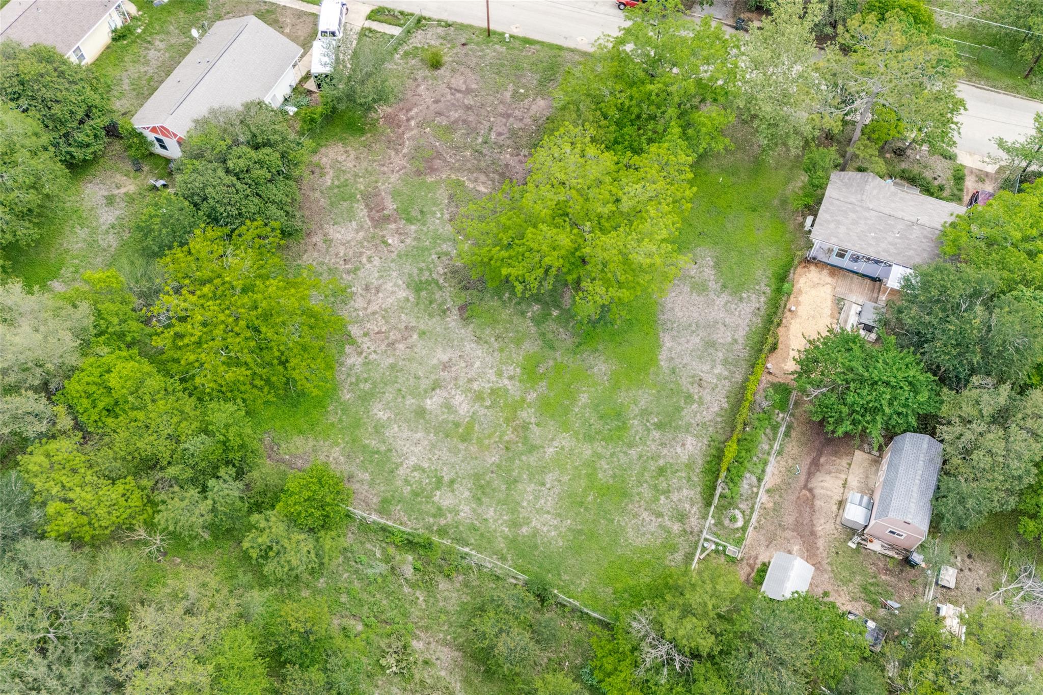 Expansive lot featuring mature trees and open gra
