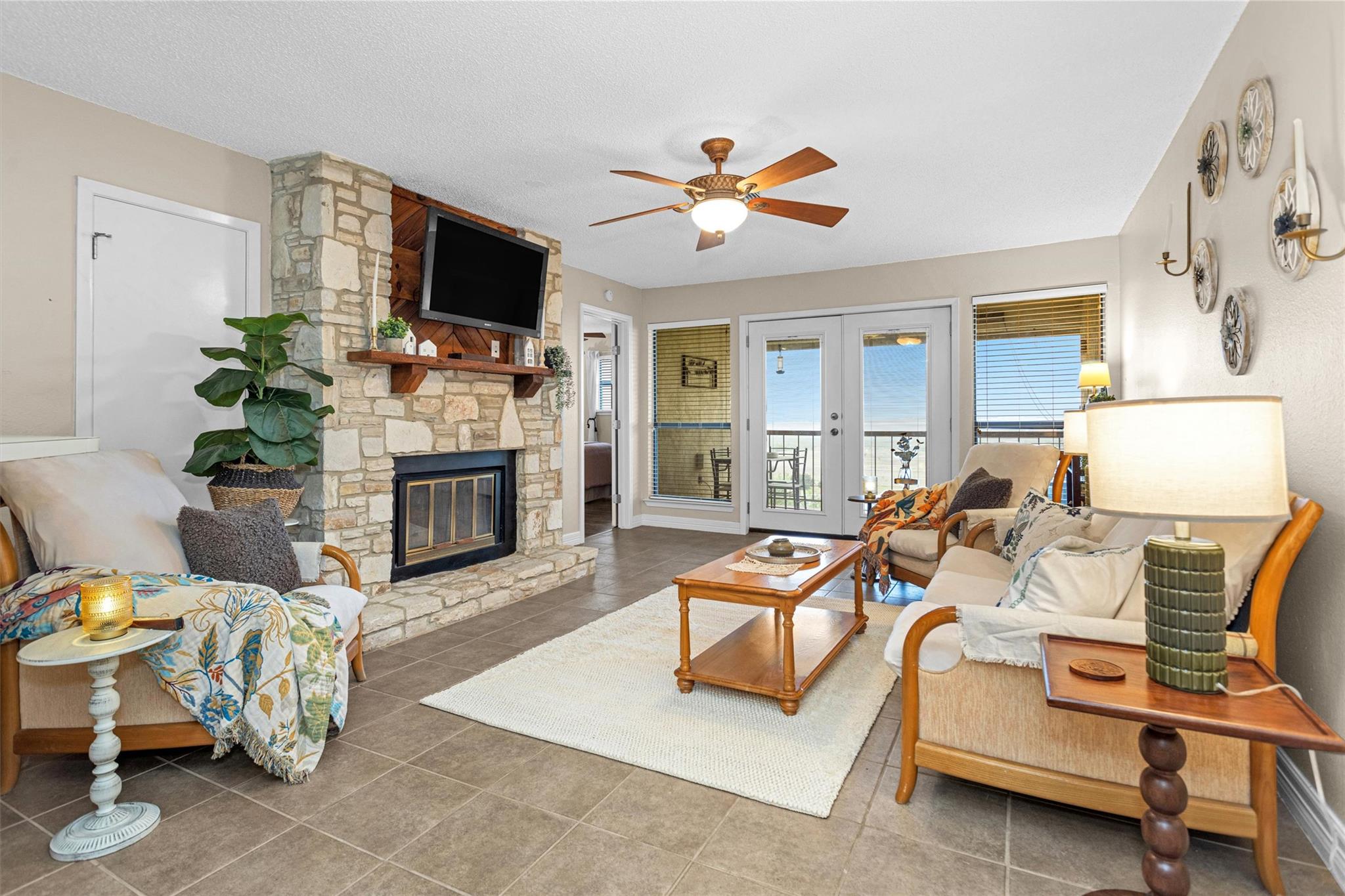 Spacious living area featuring a stone-clad firep