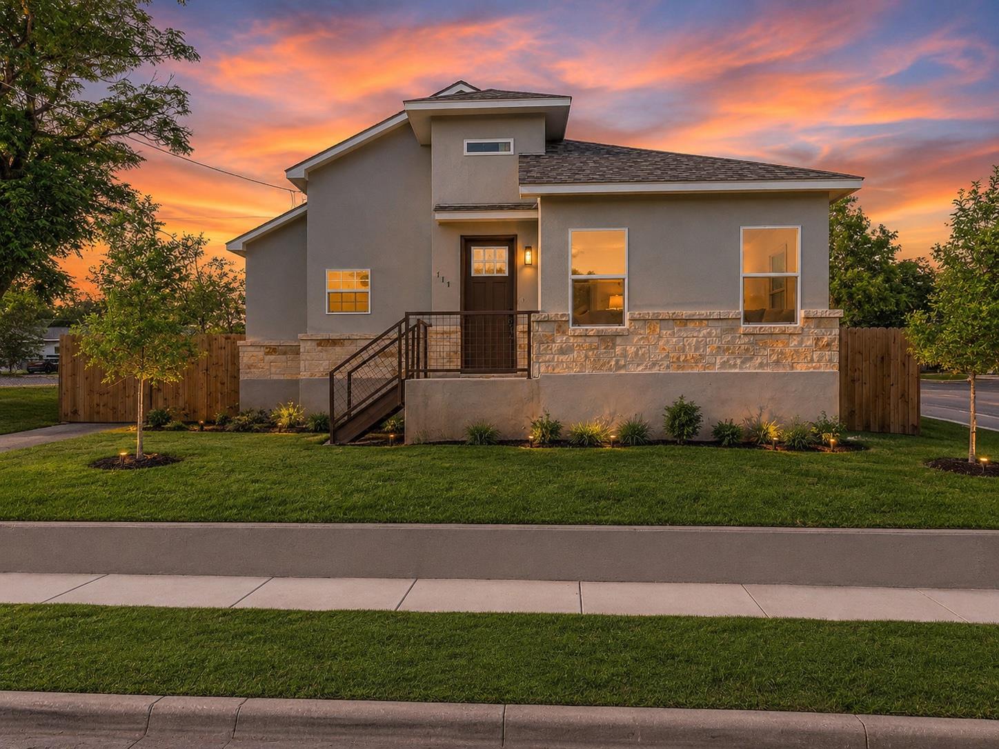A striking modern facade with stone accents and i