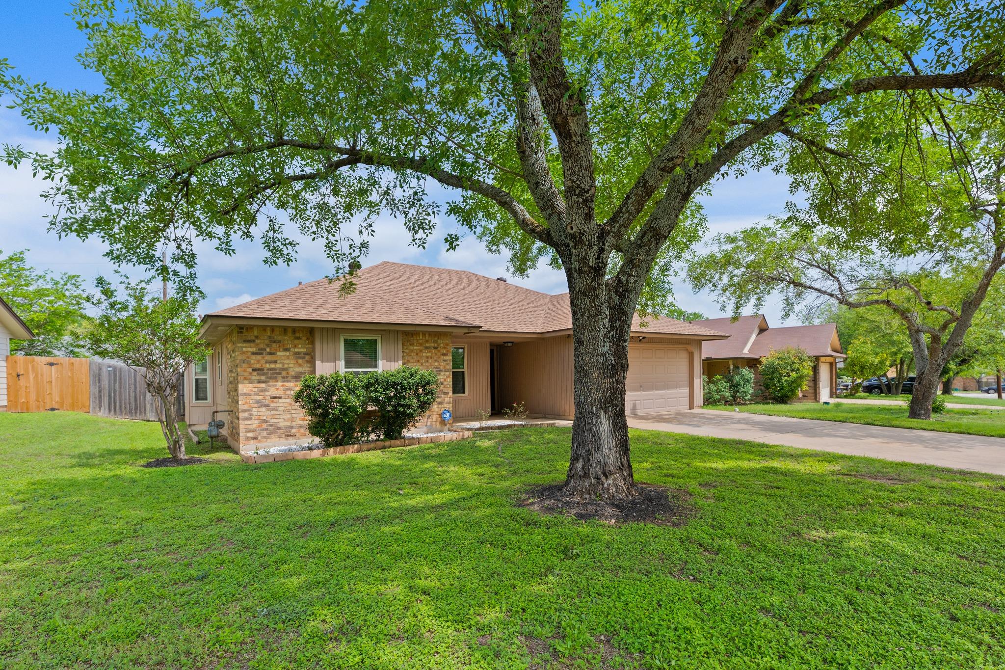 Traditional brick and stucco exterior with a brow