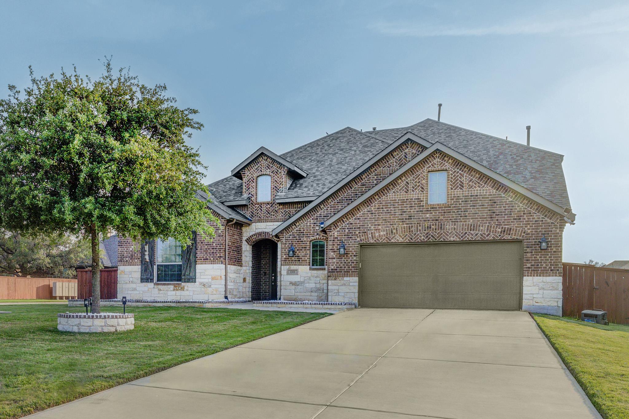 Brick and stone facade featuring a prominent two-