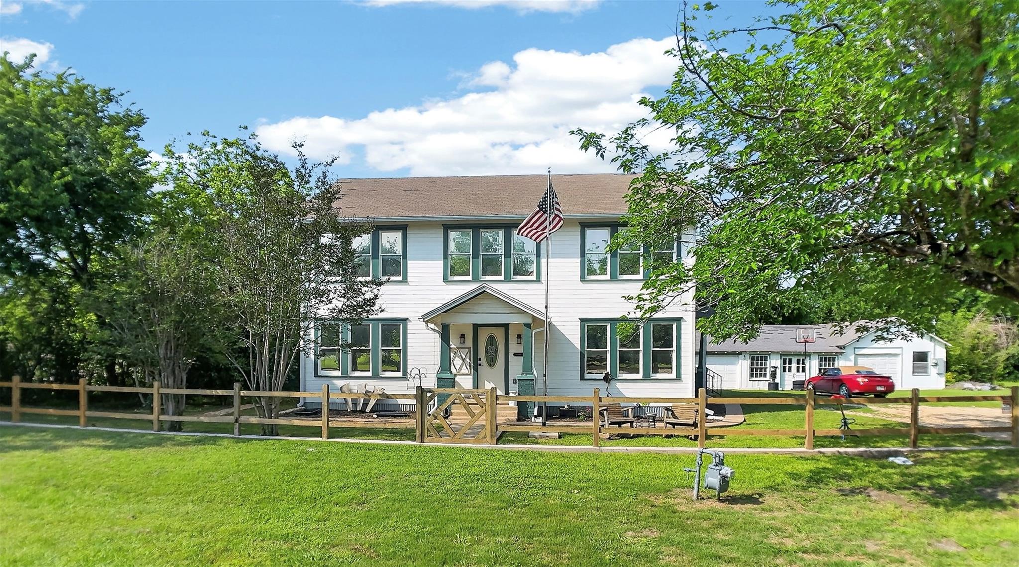 Traditional two-story residence featuring a white