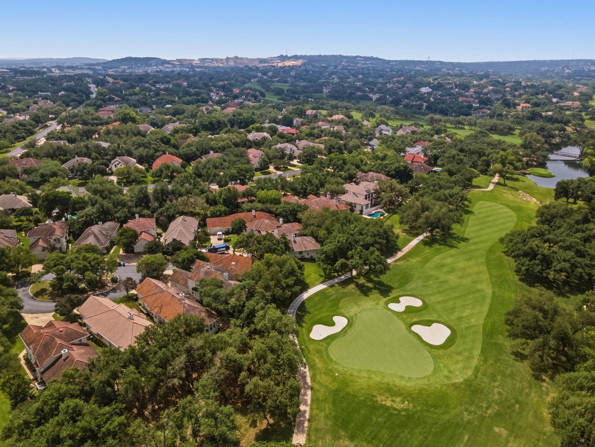 Expansive golf course green featuring a sand trap