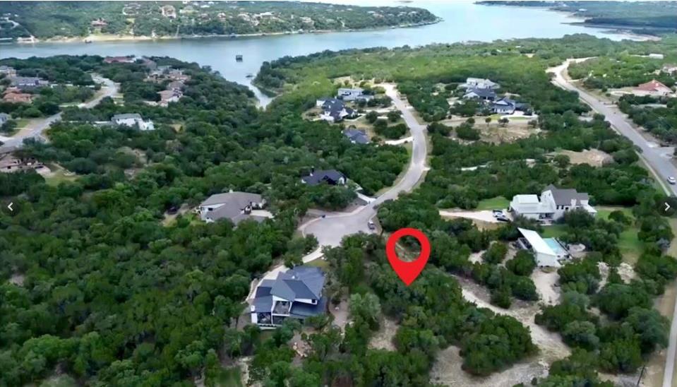 Wooded property with surrounding residences and a