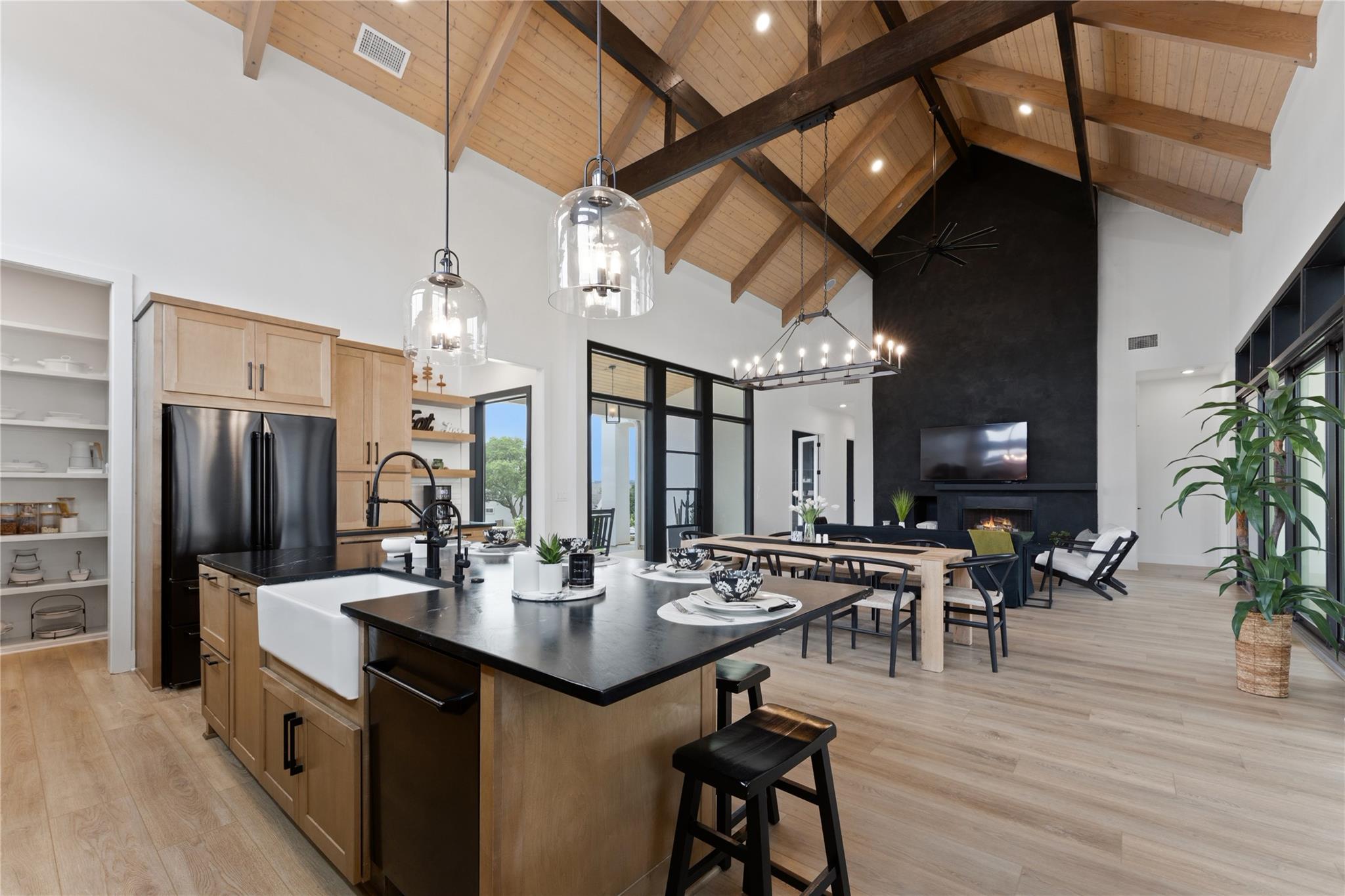 Open-concept living space featuring vaulted wood-