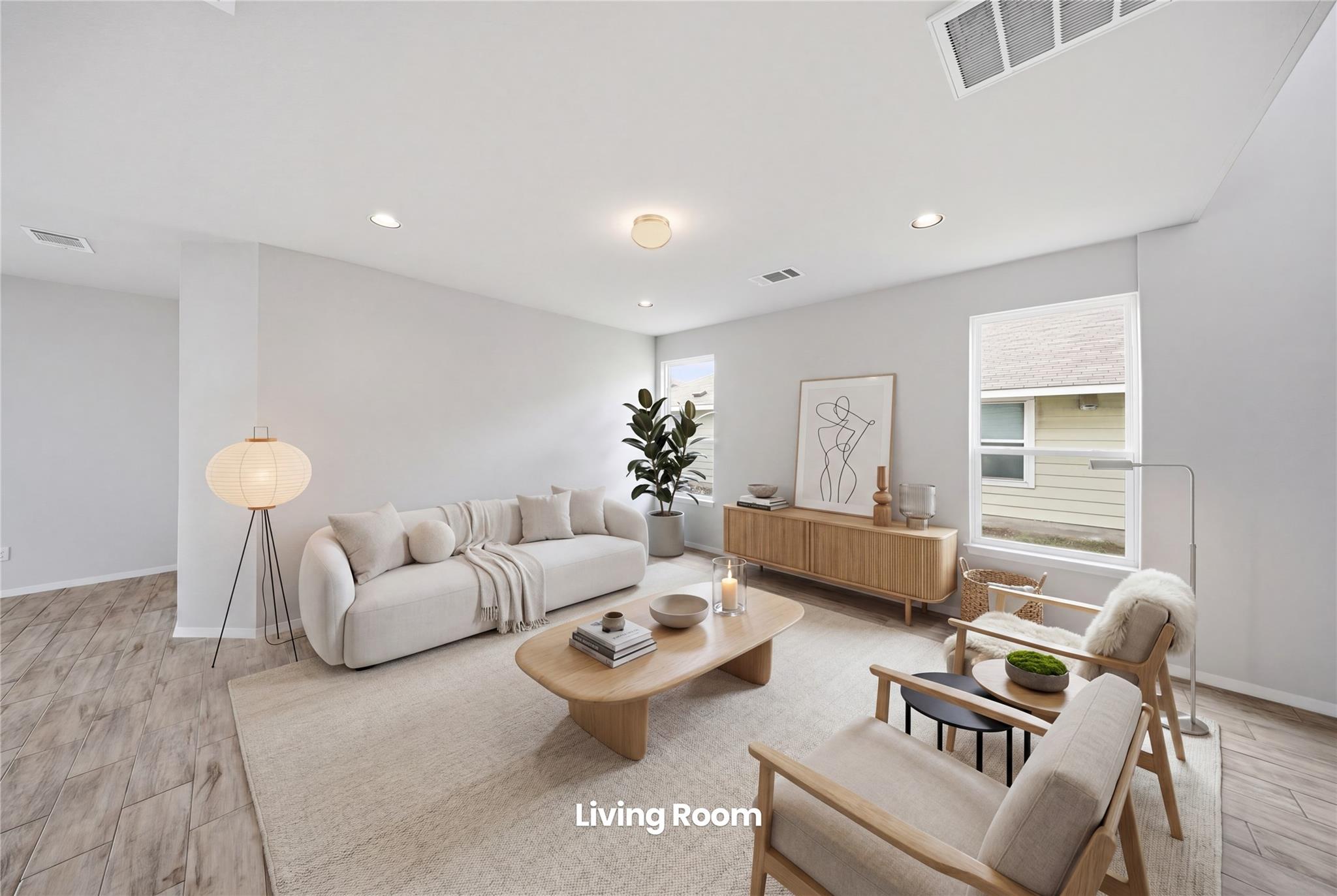 Spacious living area featuring light wood-finish 