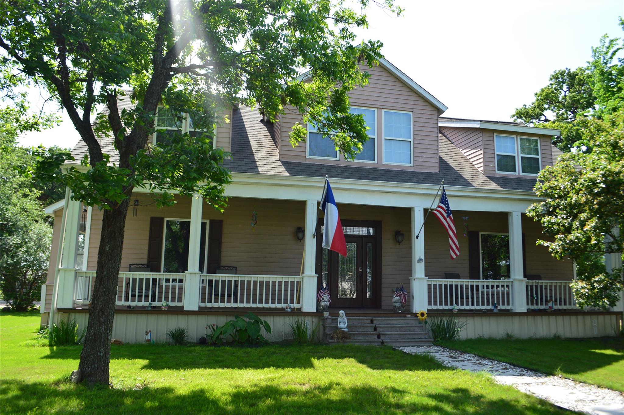 Two-story residence featuring a covered front por