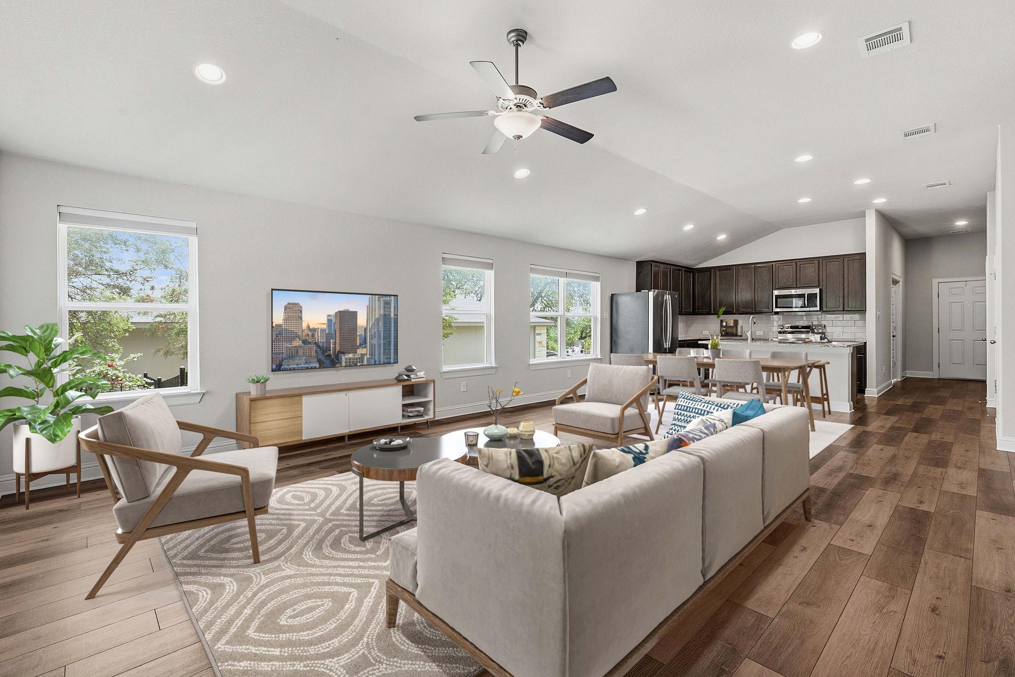 Open-concept living space featuring wood-finish f