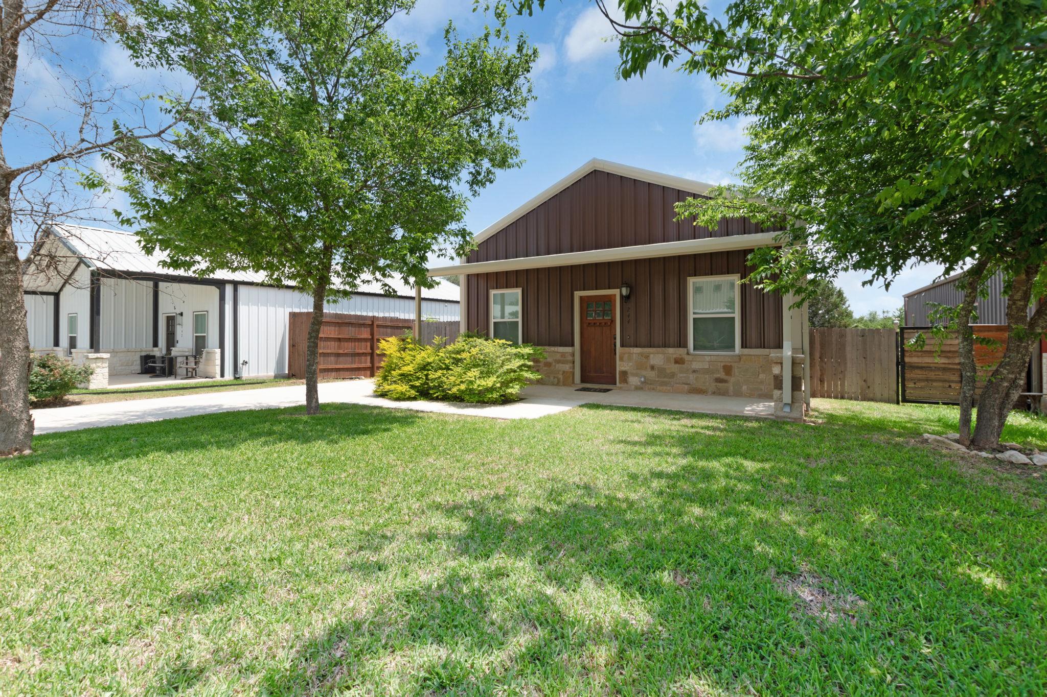 Brown metal siding exterior with a stone veneer f