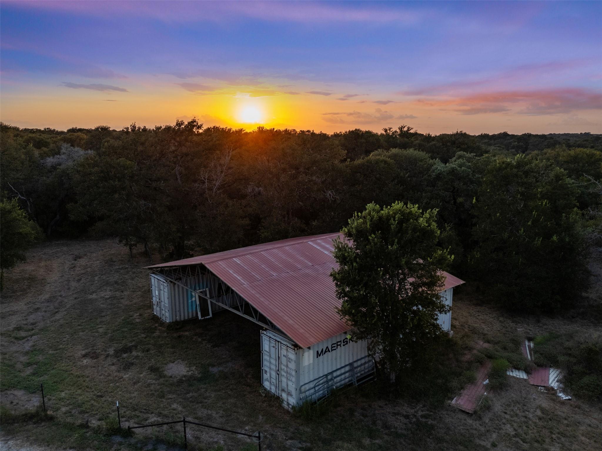 A metal roof spans across shipping containers to 