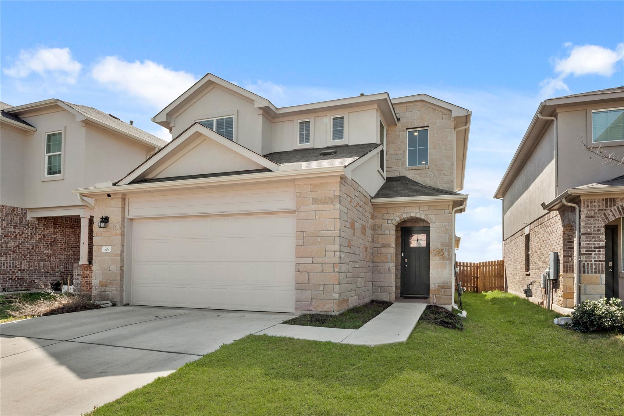 Contemporary two-story residence featuring a ston