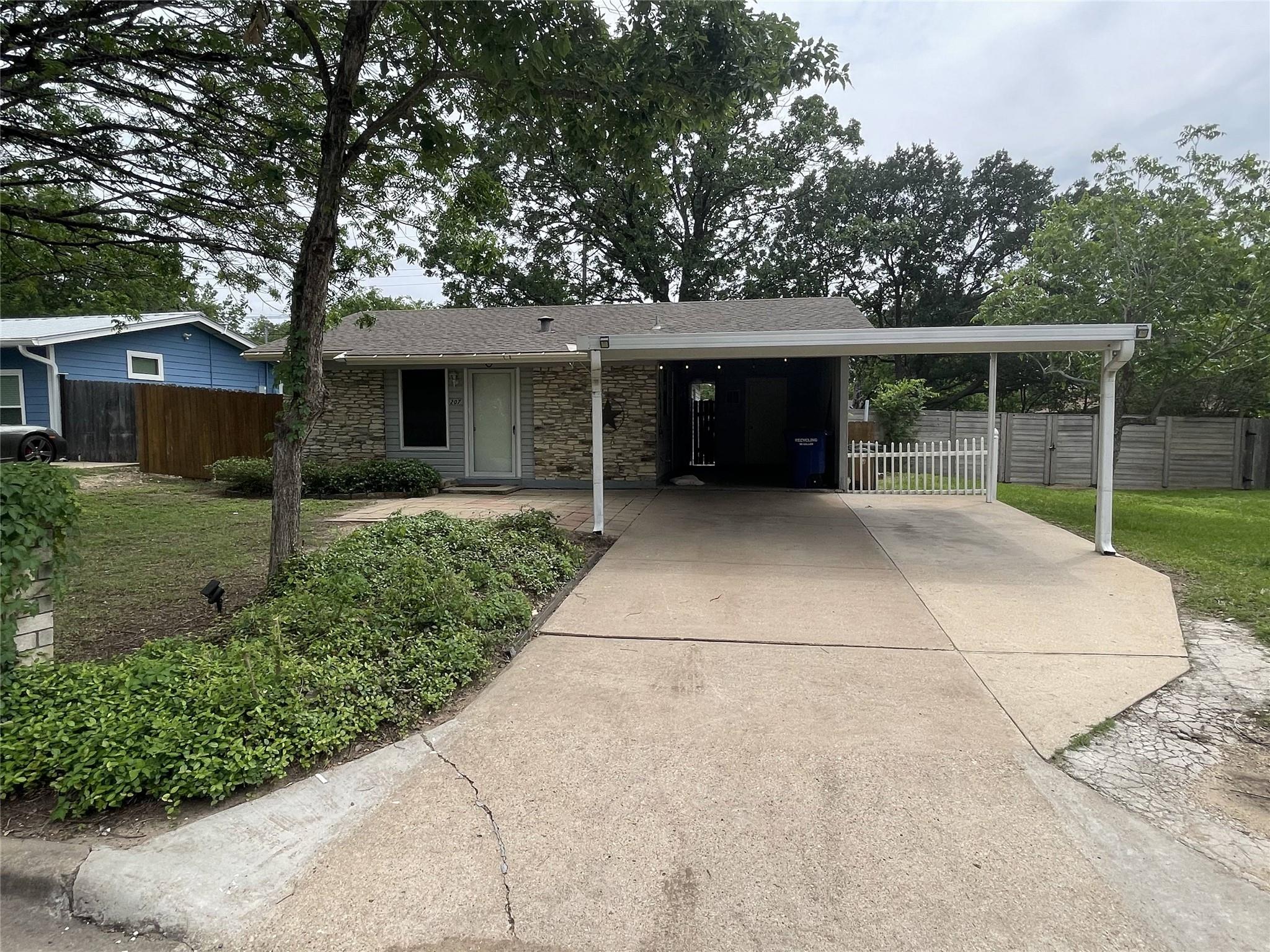 A welcoming front exterior features a covered car