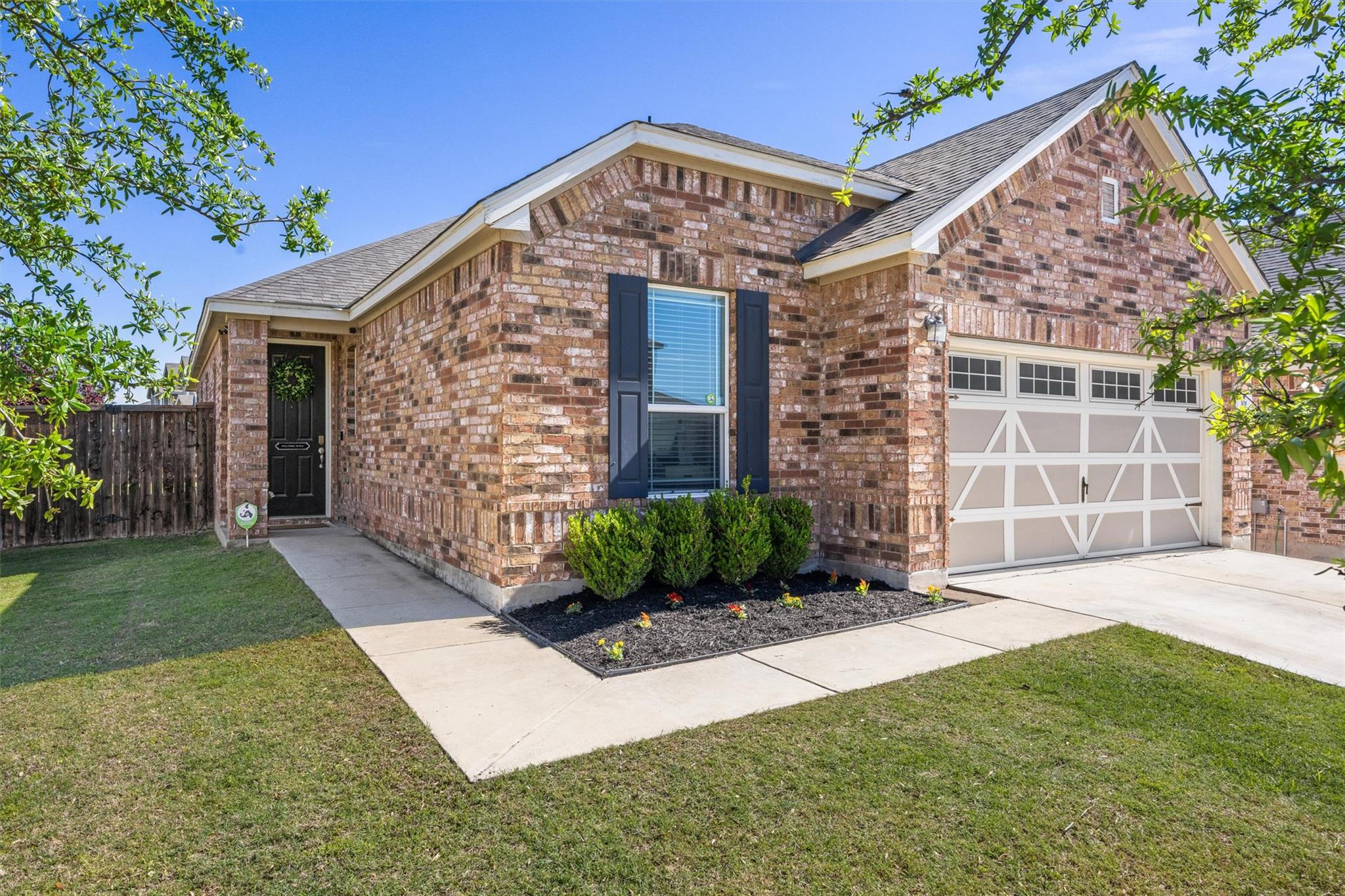 Brick facade residence featuring a front entry, s