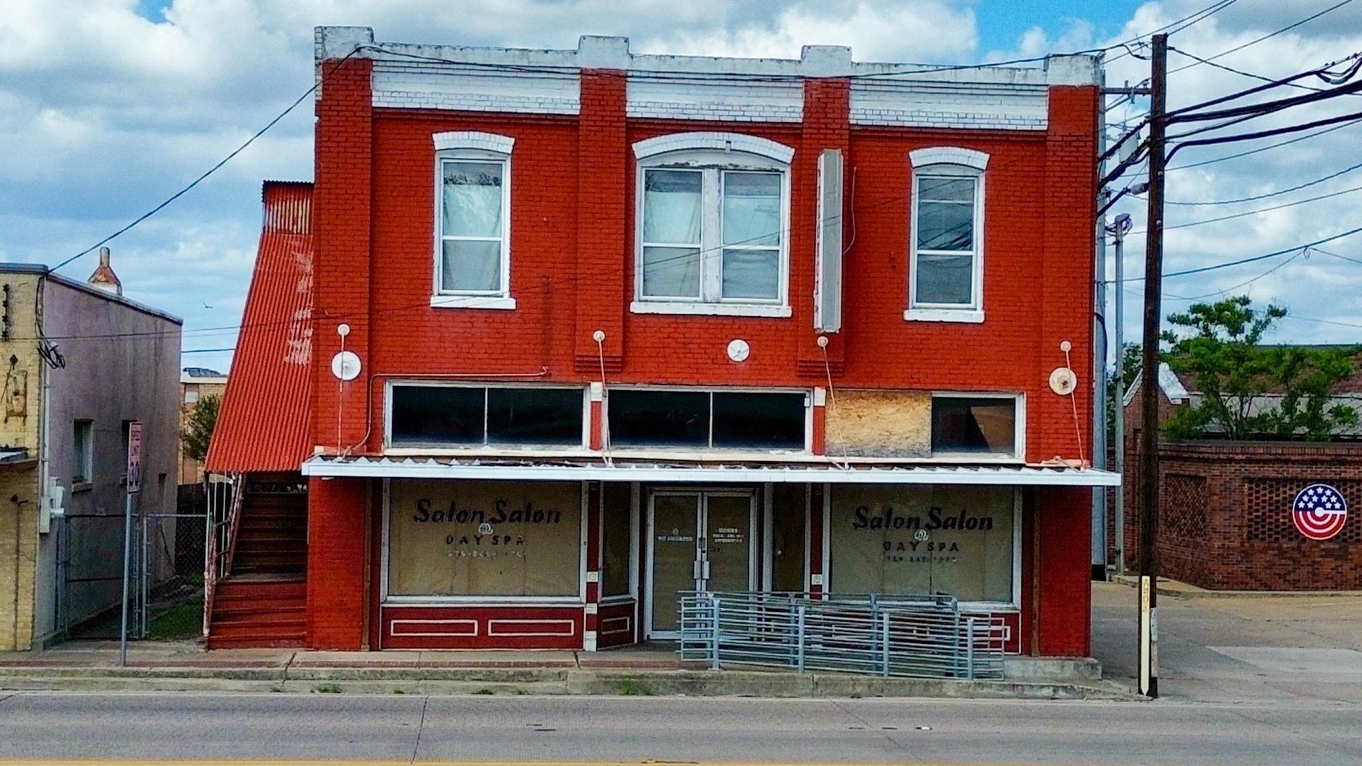 Two-story commercial building featuring red brick