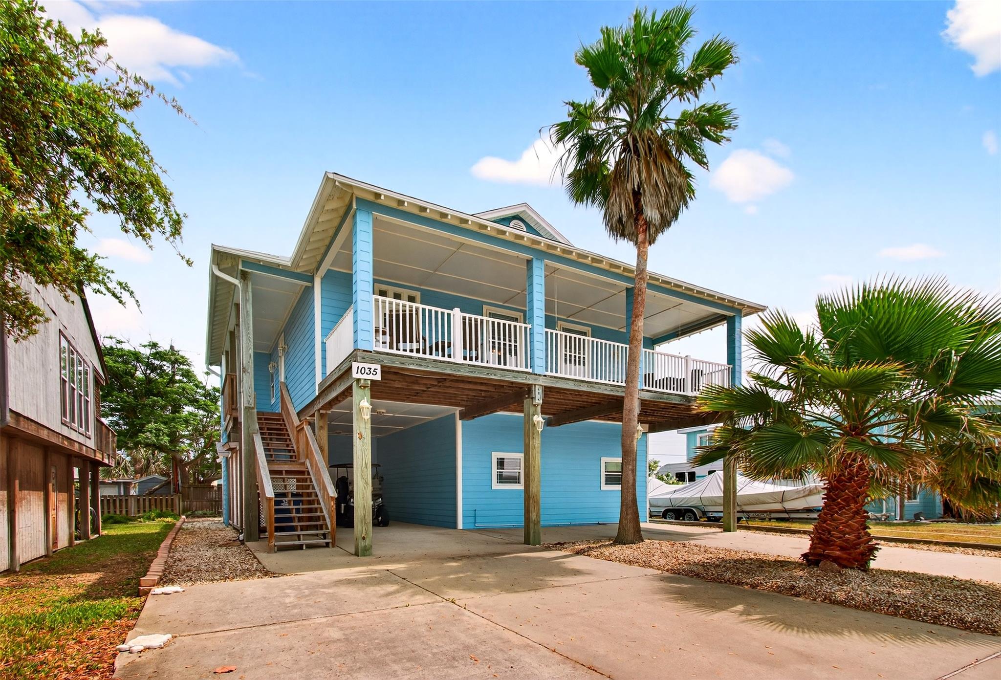 Elevated coastal residence featuring a double-sto