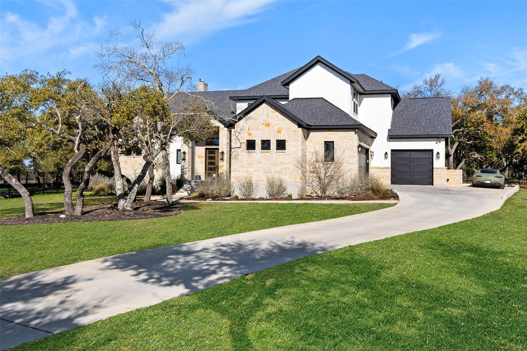 View of front of property with a front lawn, driv