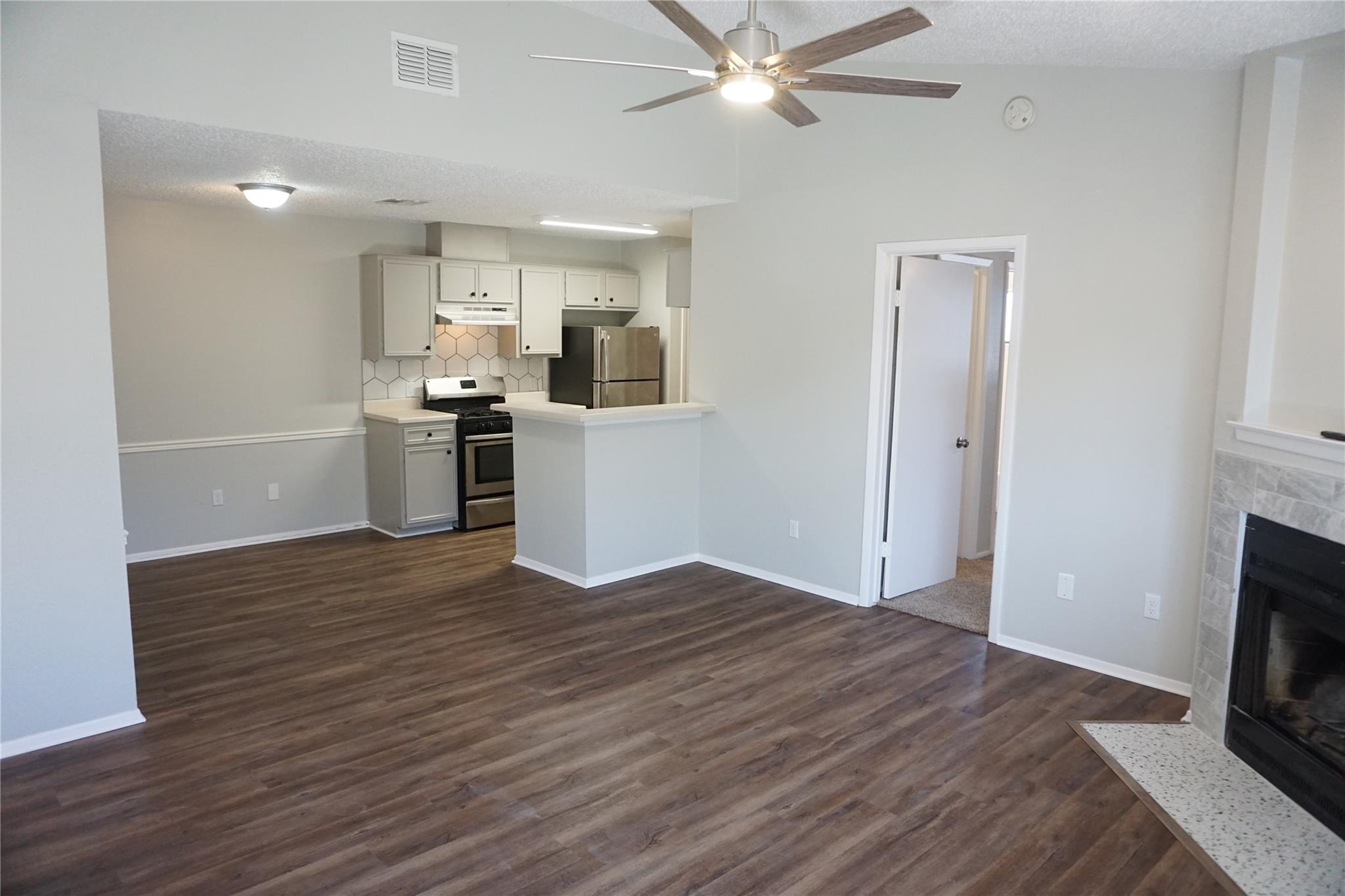 Open-concept living space featuring wood-finish f