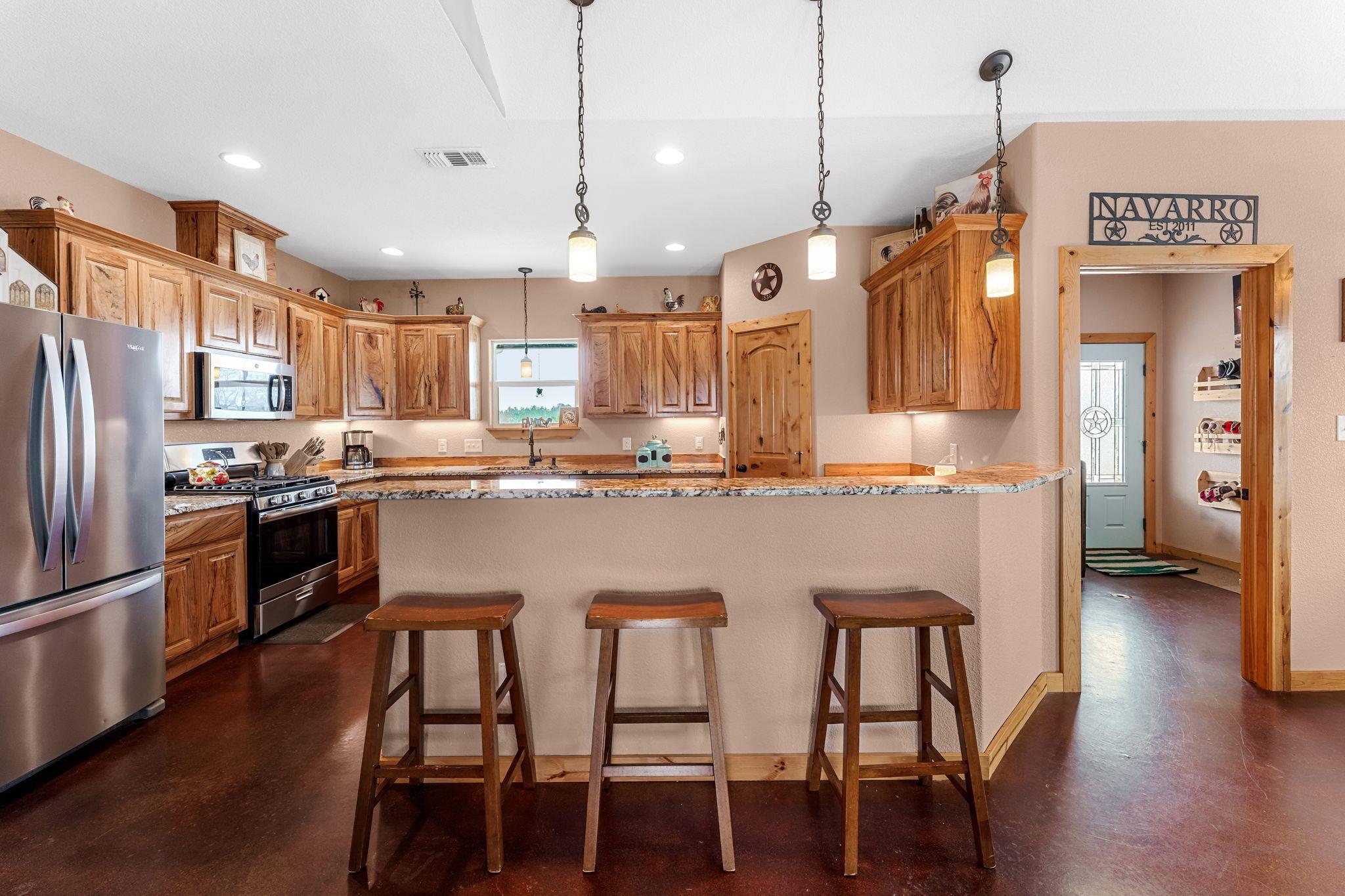 Kitchen featuring wood cabinetry, stainless steel