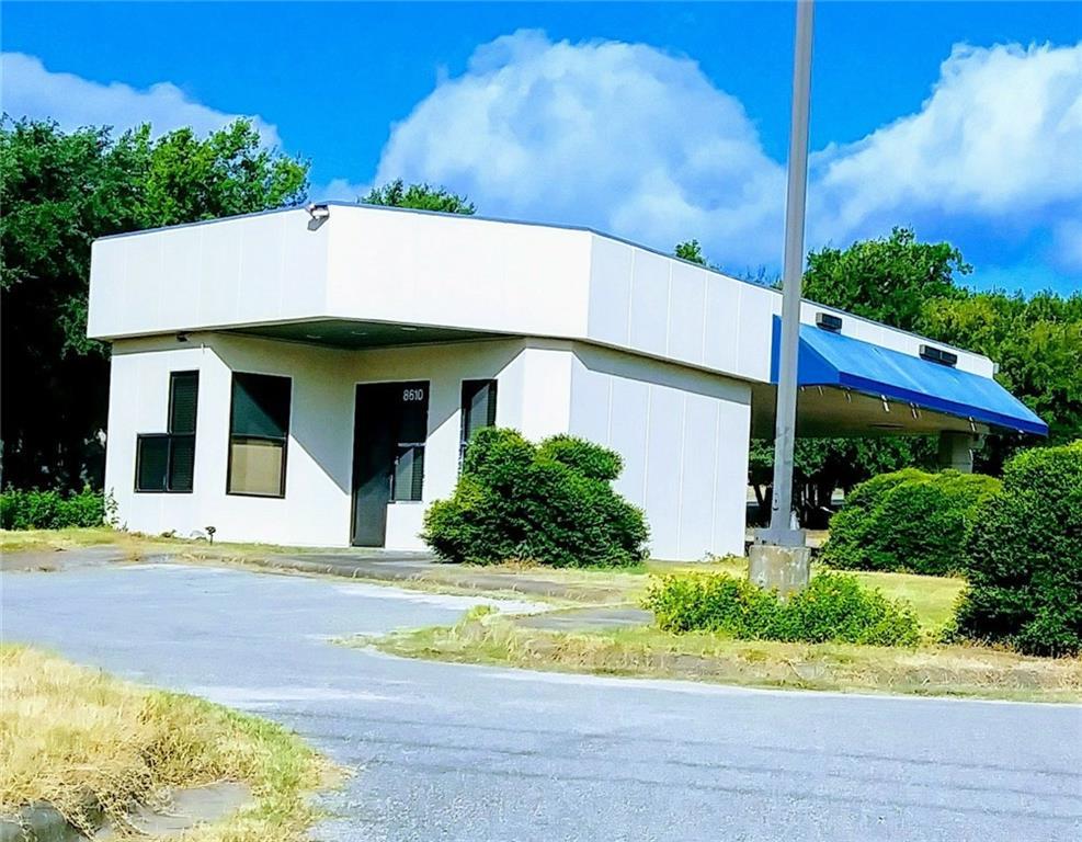 Commercial building featuring a white exterior, m