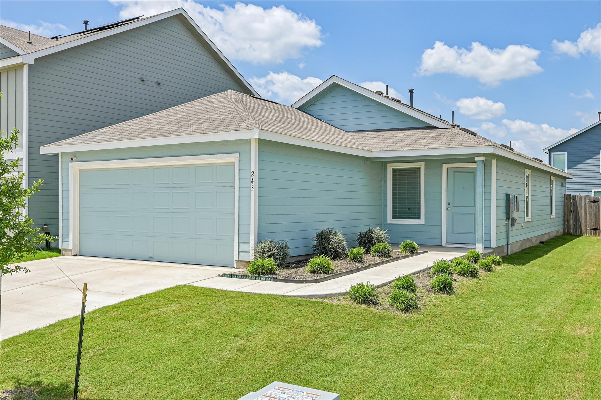 Light blue siding exterior featuring a covered en