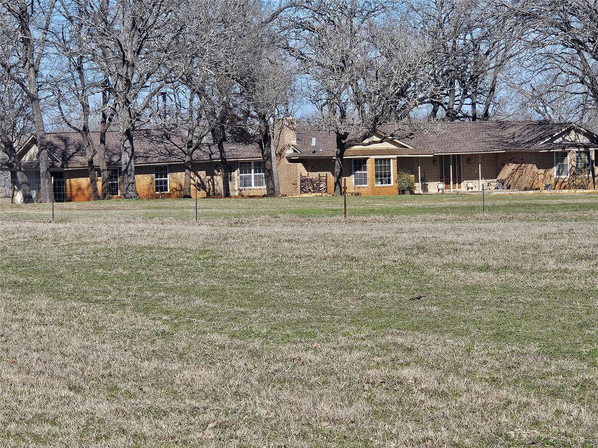 Expansive outdoor area featuring a large grassy f