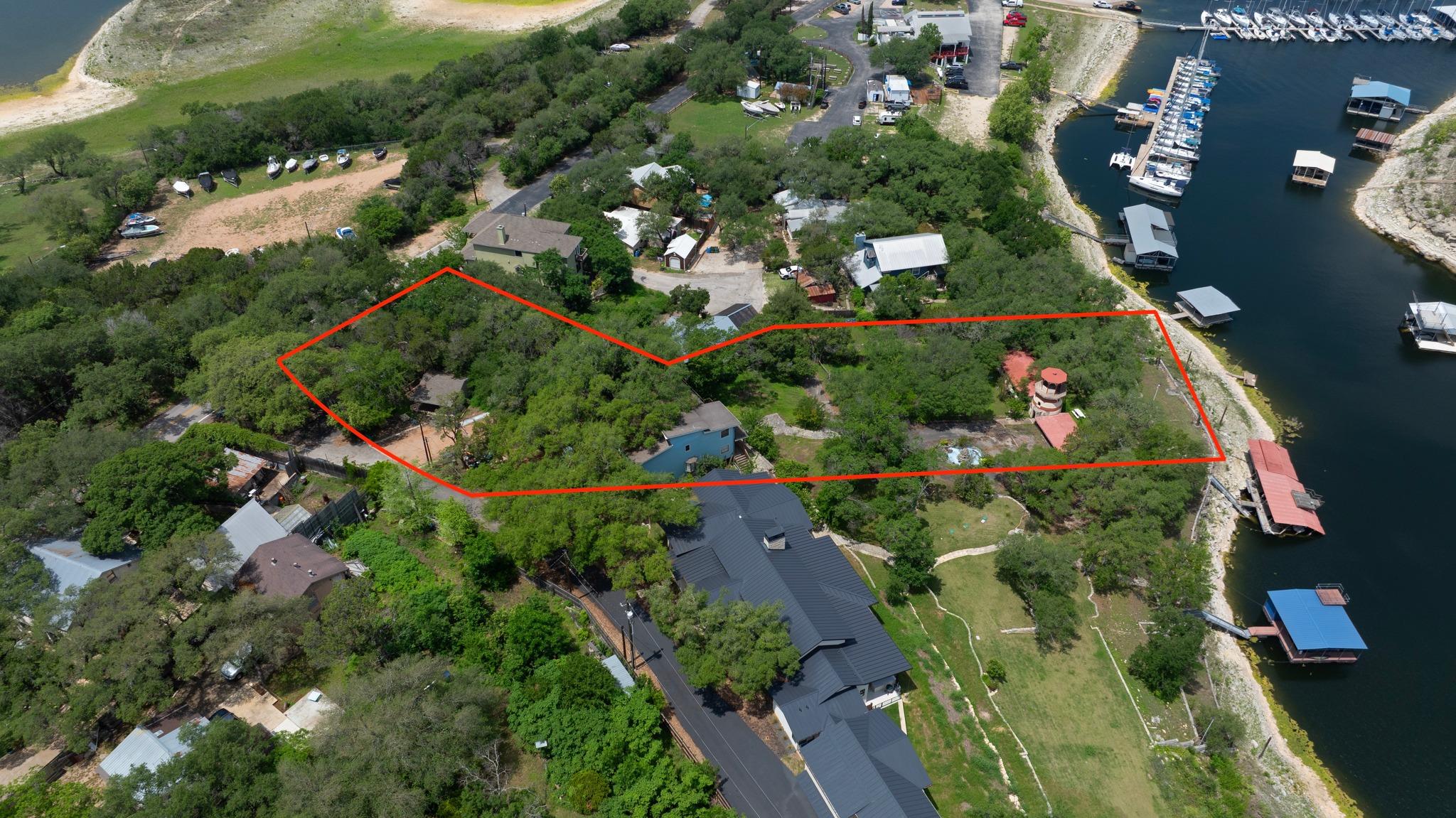 Aerial view showcasing a treed property outlined 