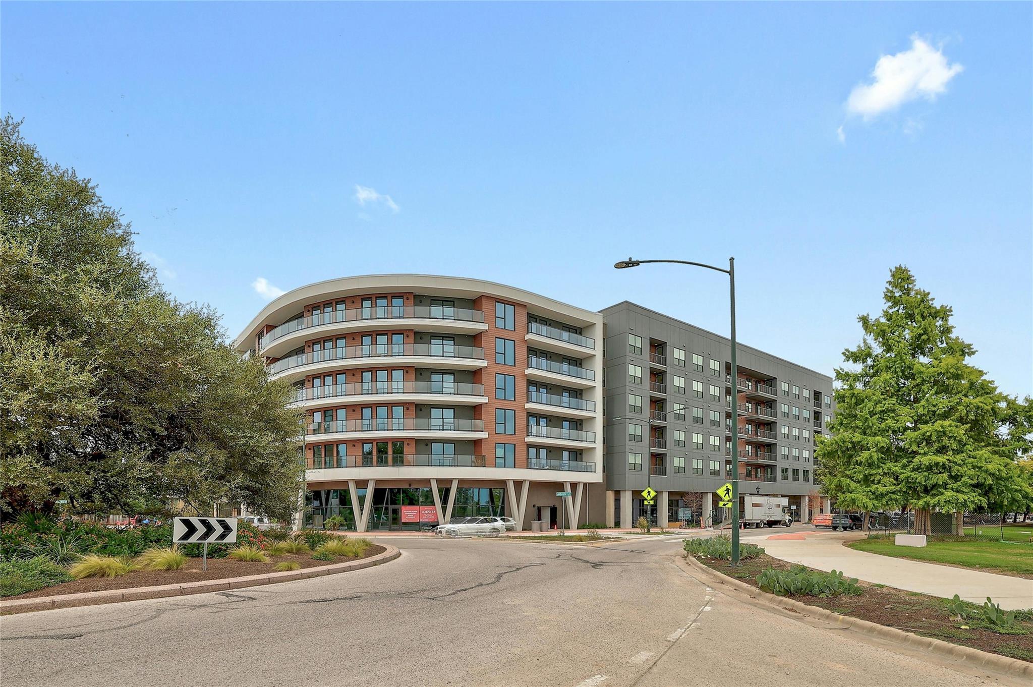 Contemporary multi-story building featuring a cur