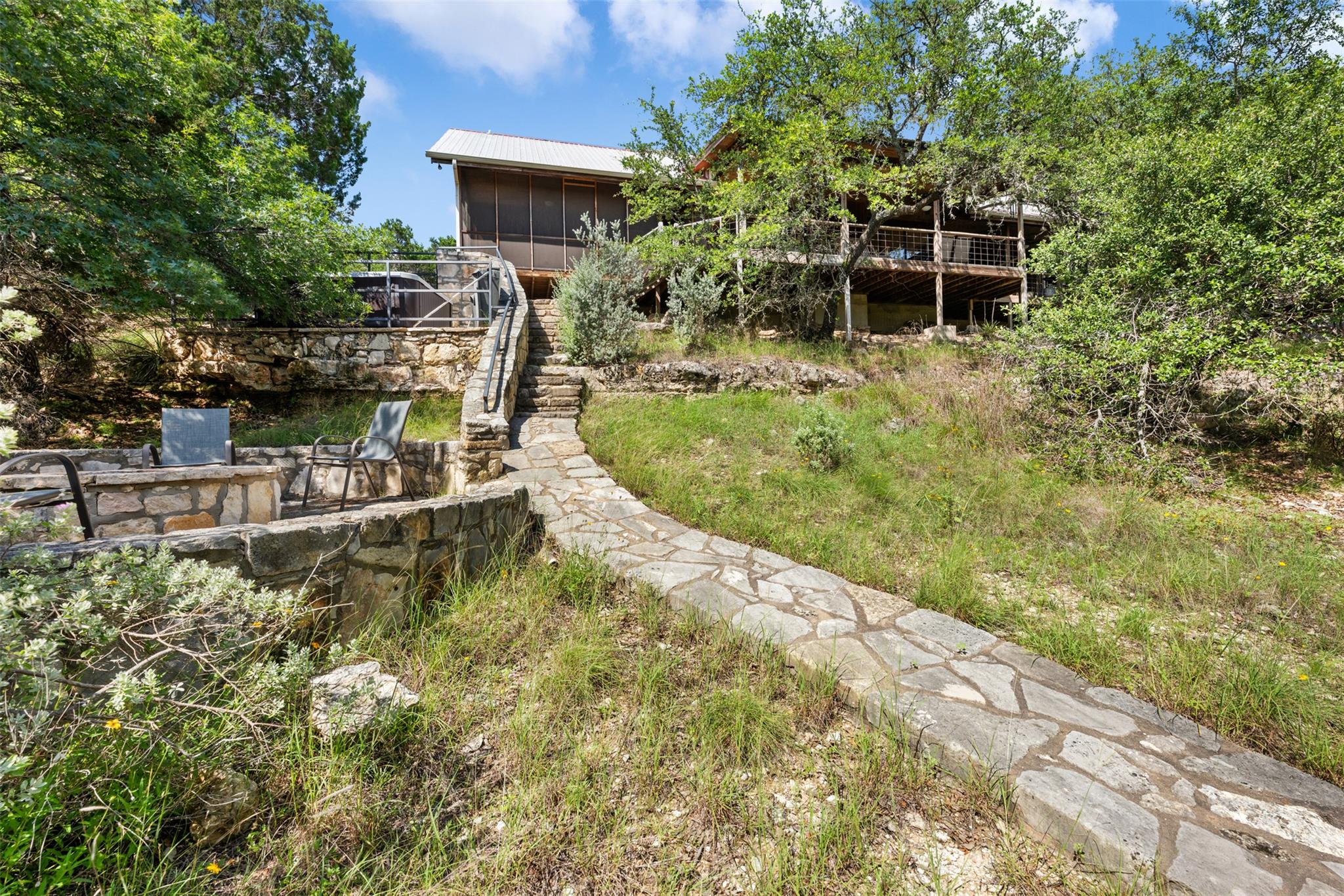 A flagstone path winds through natural landscapin