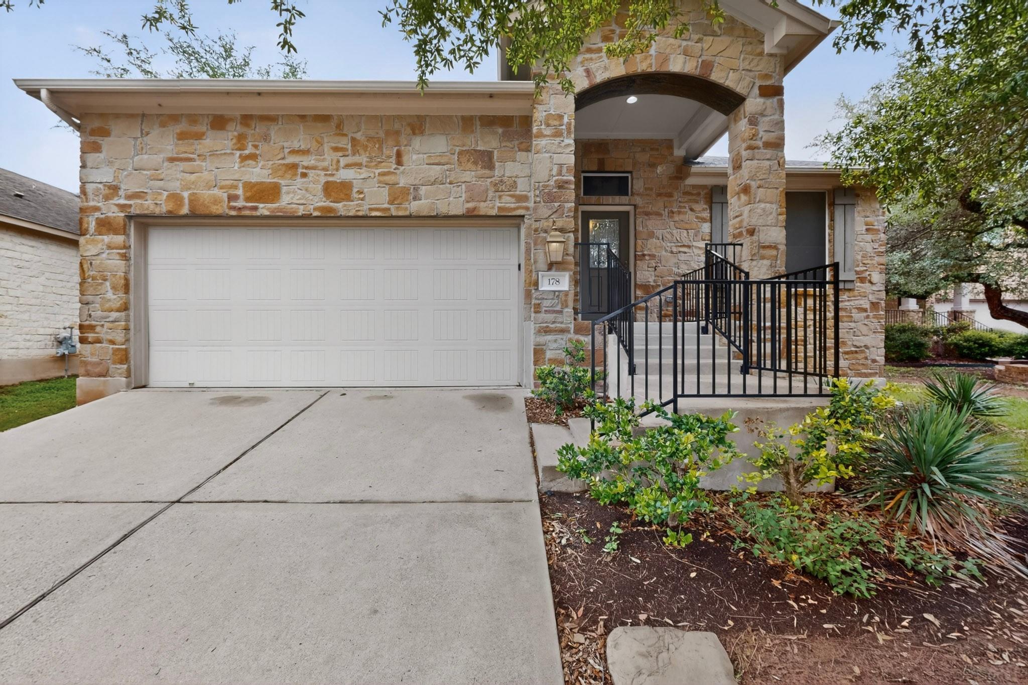 Stone facade exterior featuring an arched entrywa