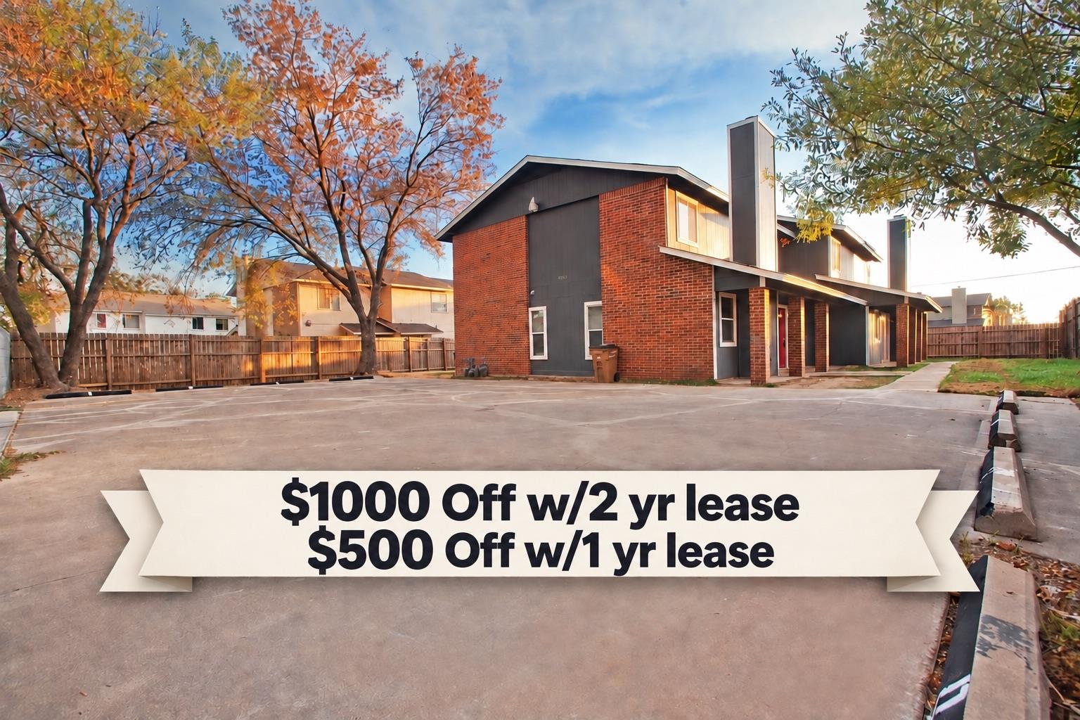 Mature trees frame a classic brick multi-unit ext