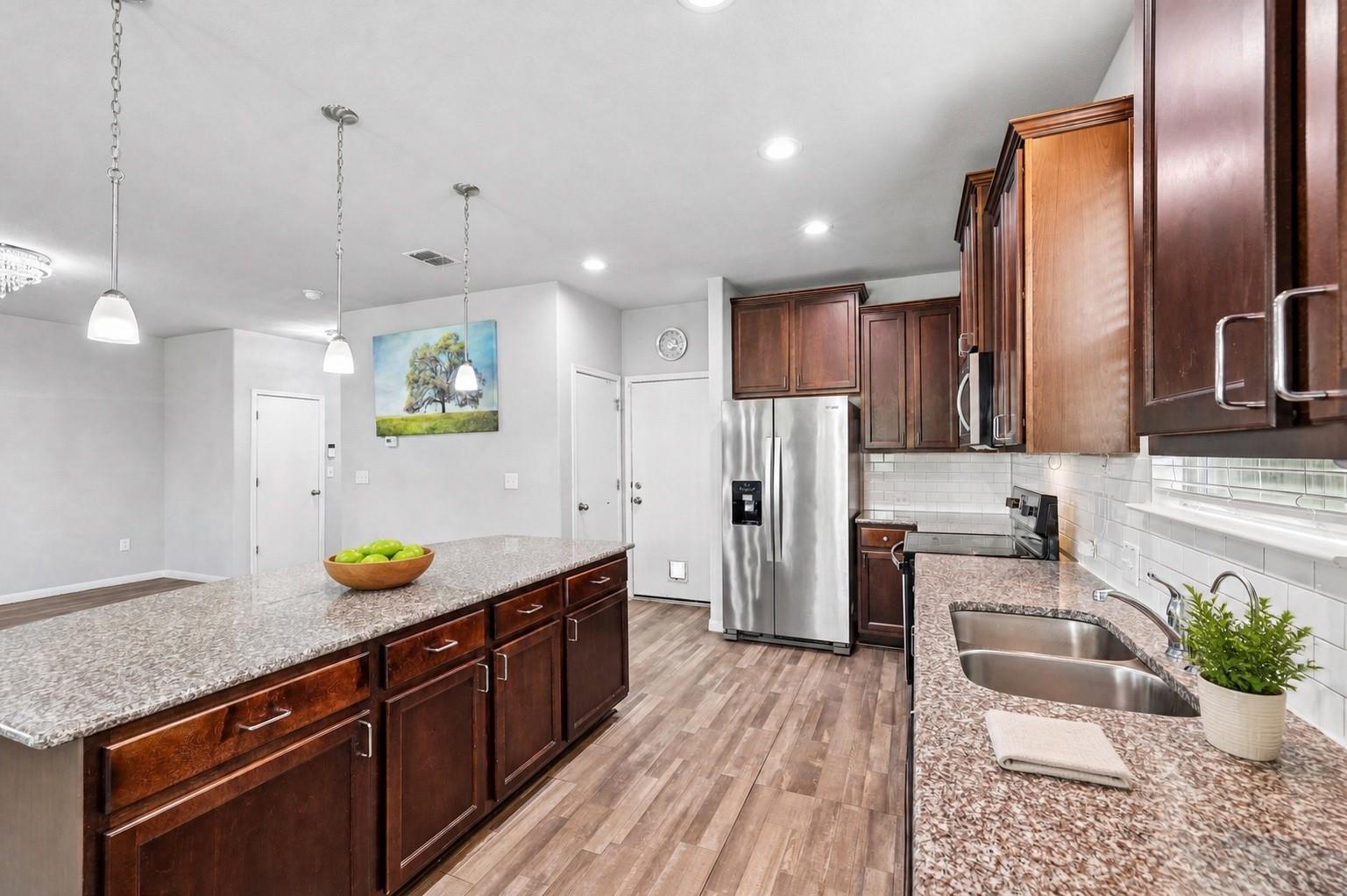 Rich wood cabinetry paired with granite counterto