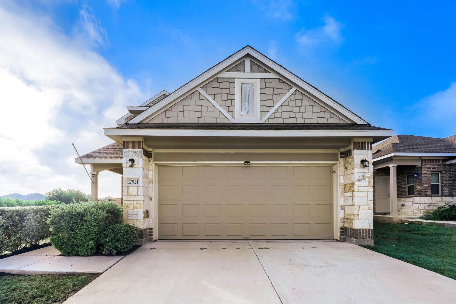 A welcoming facade with a neutral-toned garage do