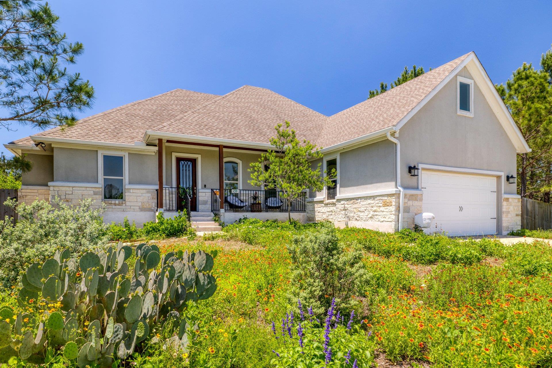 Stucco and stone exterior with a covered front po