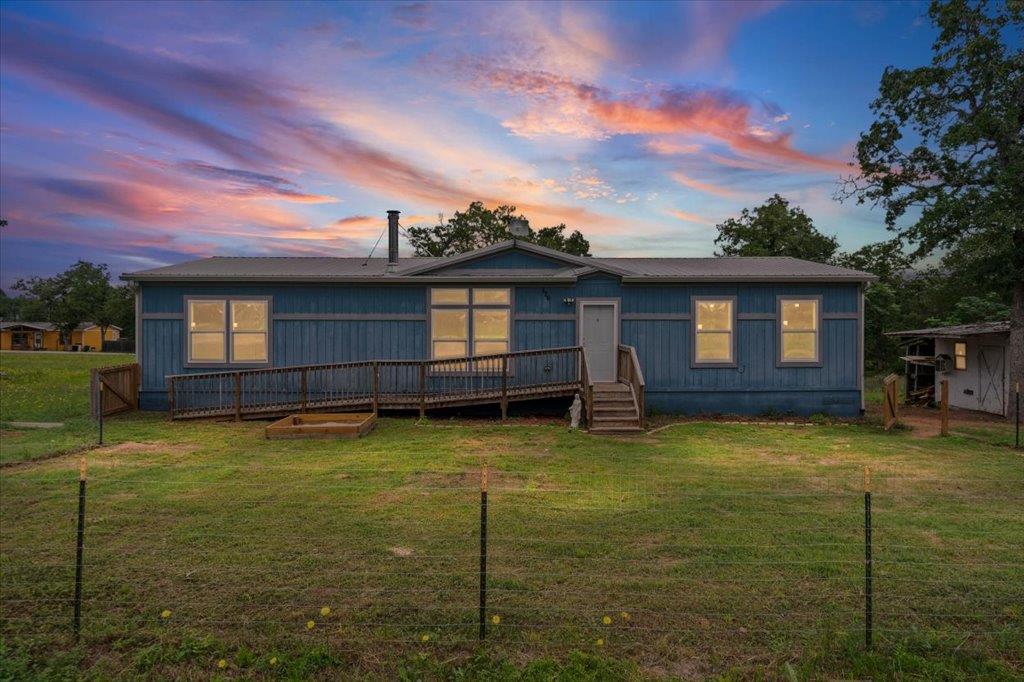 Single-story residence featuring blue siding, mul