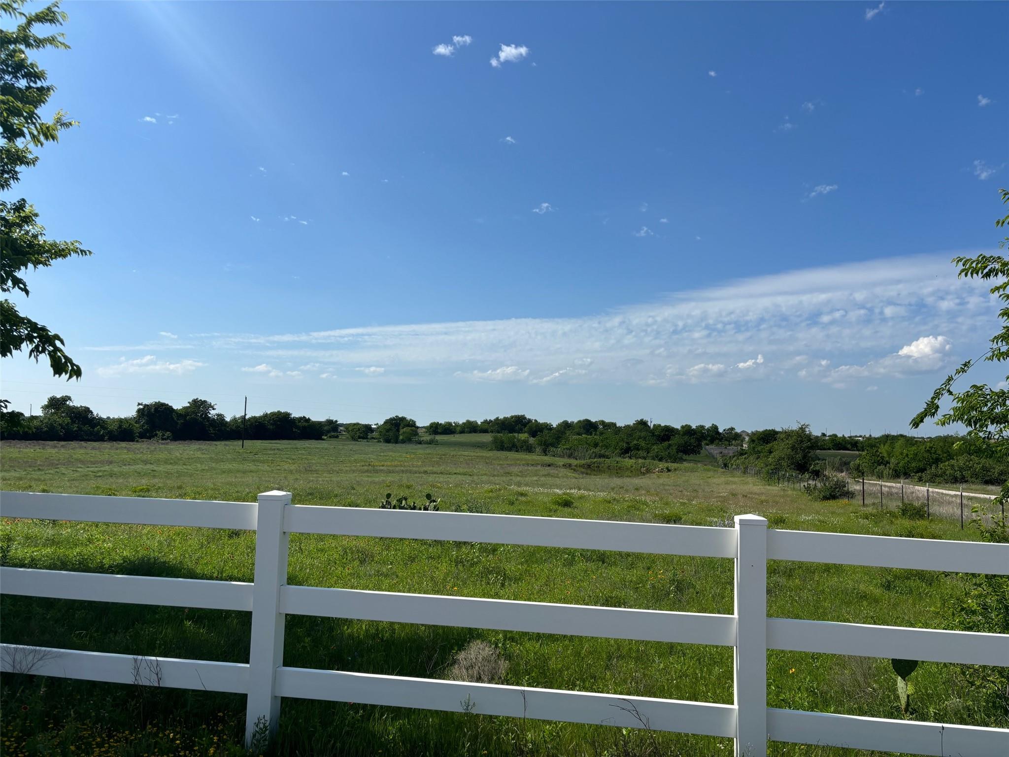 Expansive open field bordered by a multi-rail whi