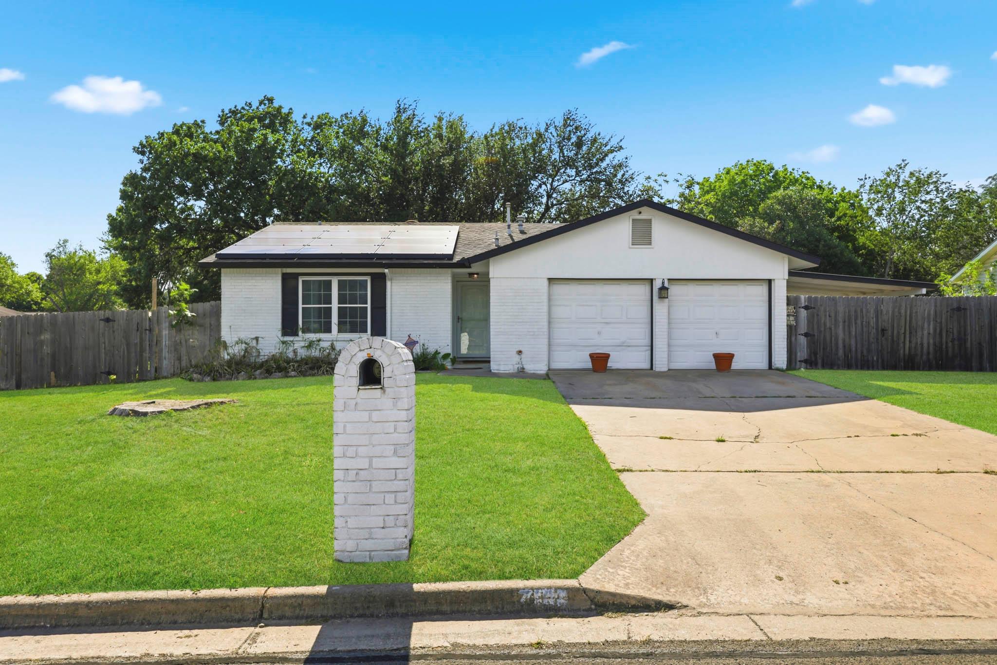 A well-maintained lawn welcomes you to this resid