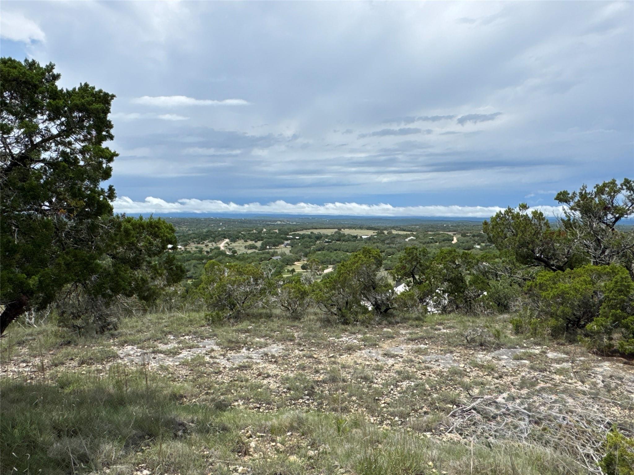 Elevated terrain with distant hills, rock and gra