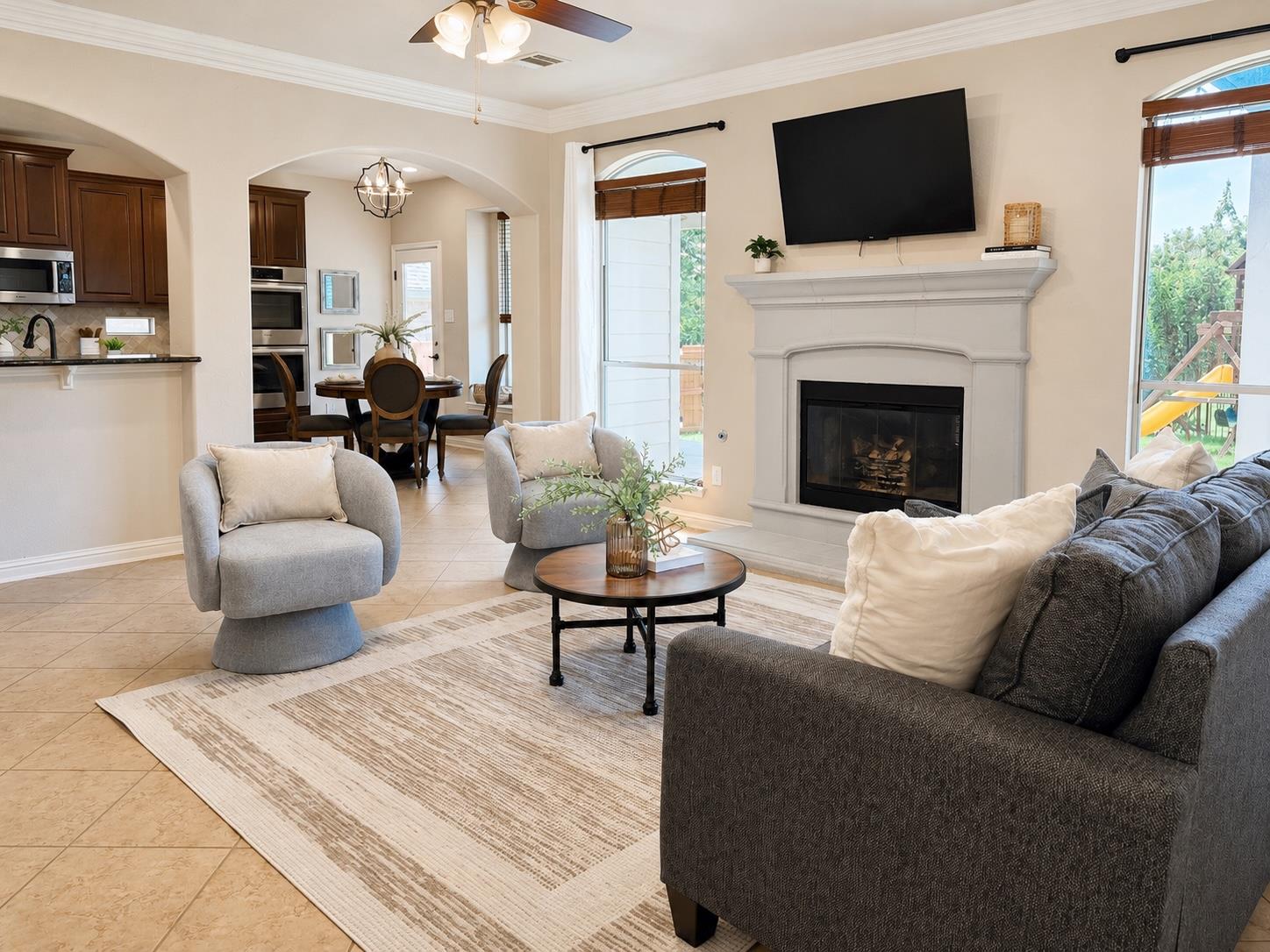 A graceful fireplace anchors this open-concept li