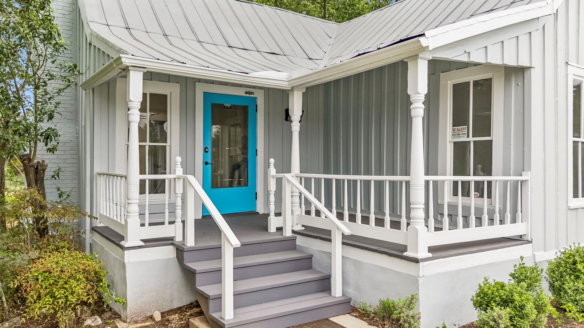 Covered front porch with decorative balusters and