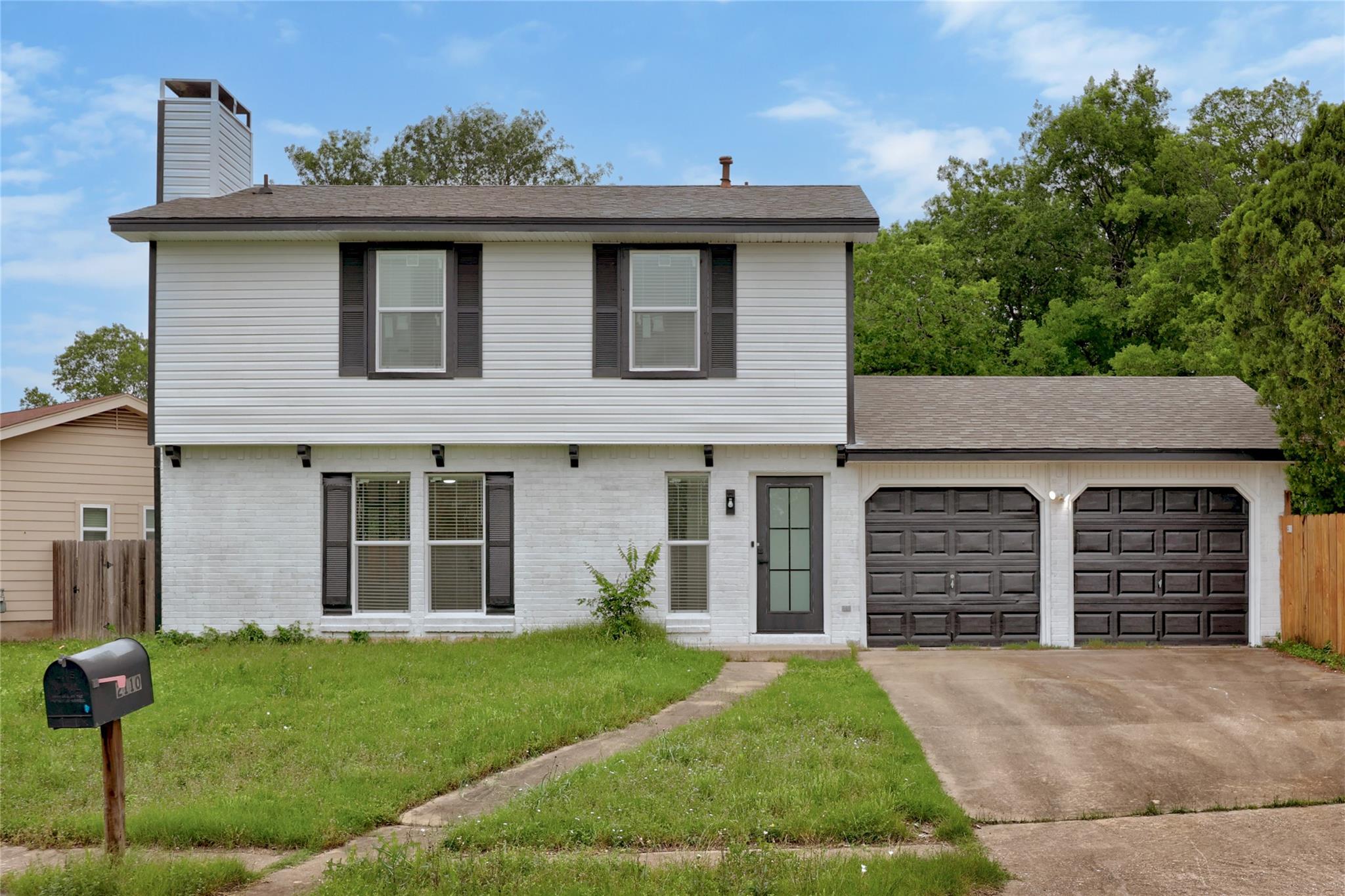 Two-story residence featuring a white painted bri