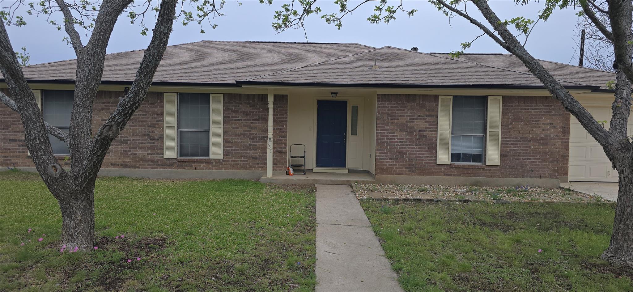 Brick exterior featuring a gabled roofline and an